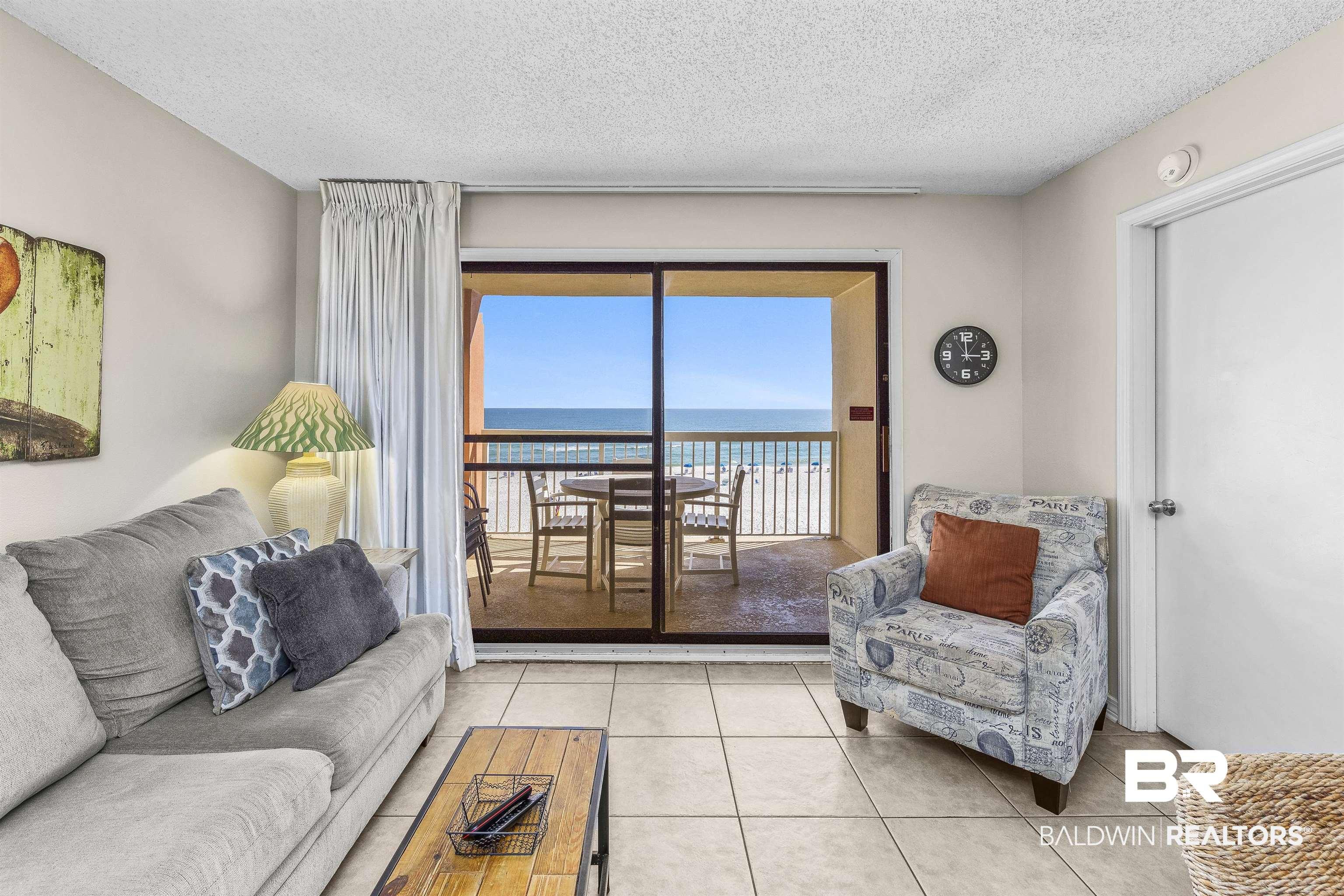 Image 4: Tiled living room with a water view and a textured ceiling