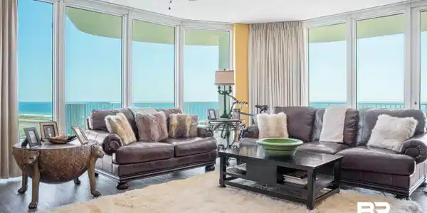 Image 2: Living area featuring floor to ceiling windows, a water view, wood finished floors, a textured ceiling, and ceiling fan