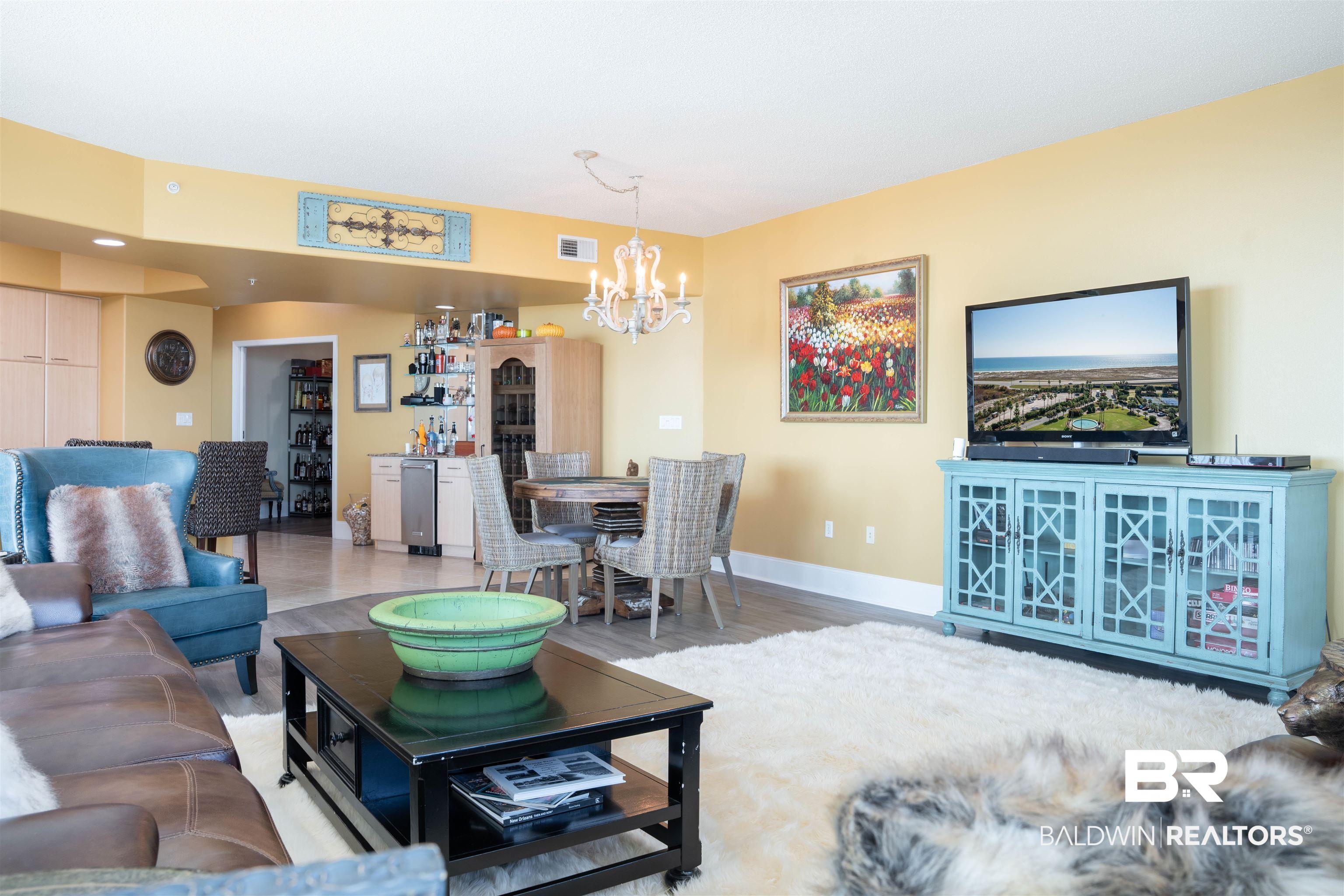 Image 3: Living room featuring wood finished floors and a chandelier
