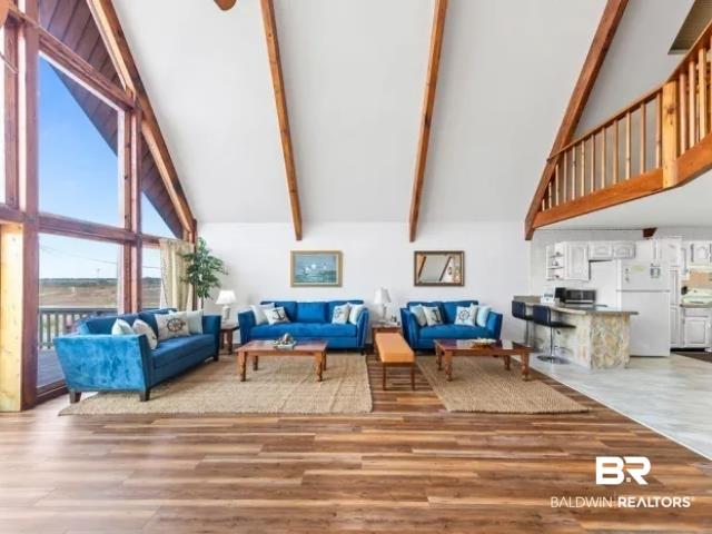 Image 4: Living room with lofted ceiling and light wood-type flooring