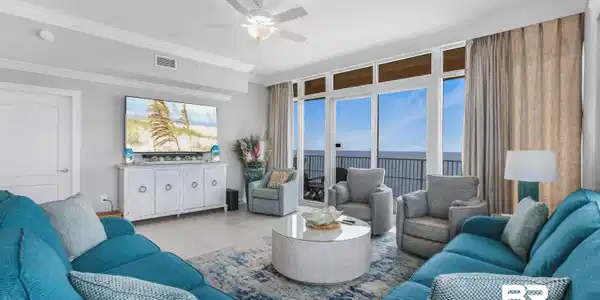 Image 2: Tiled living room featuring ornamental molding, a ceiling fan, and expansive windows