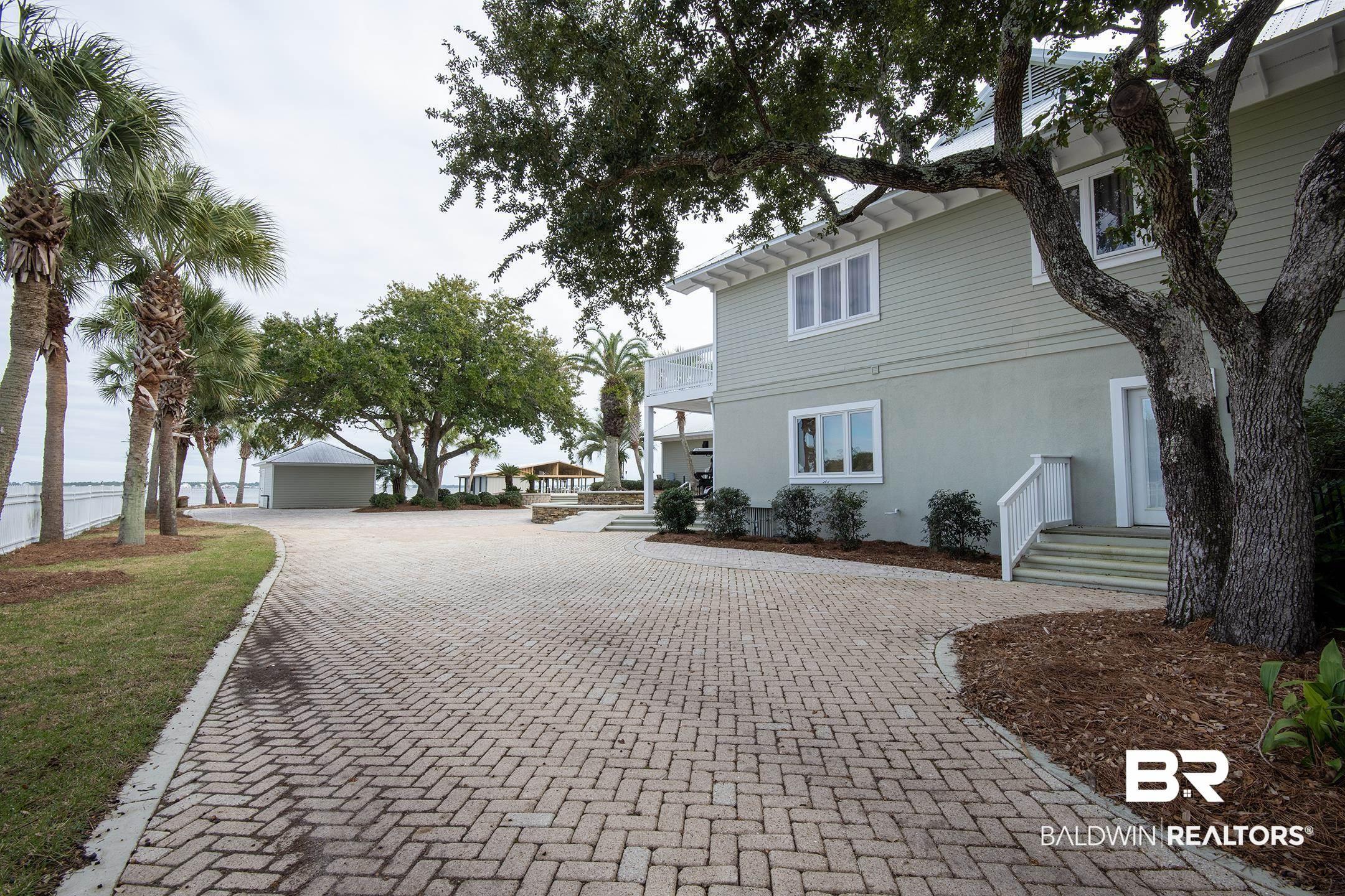 Image 3: View of side of property featuring stucco siding, a wooden deck, and a balcony