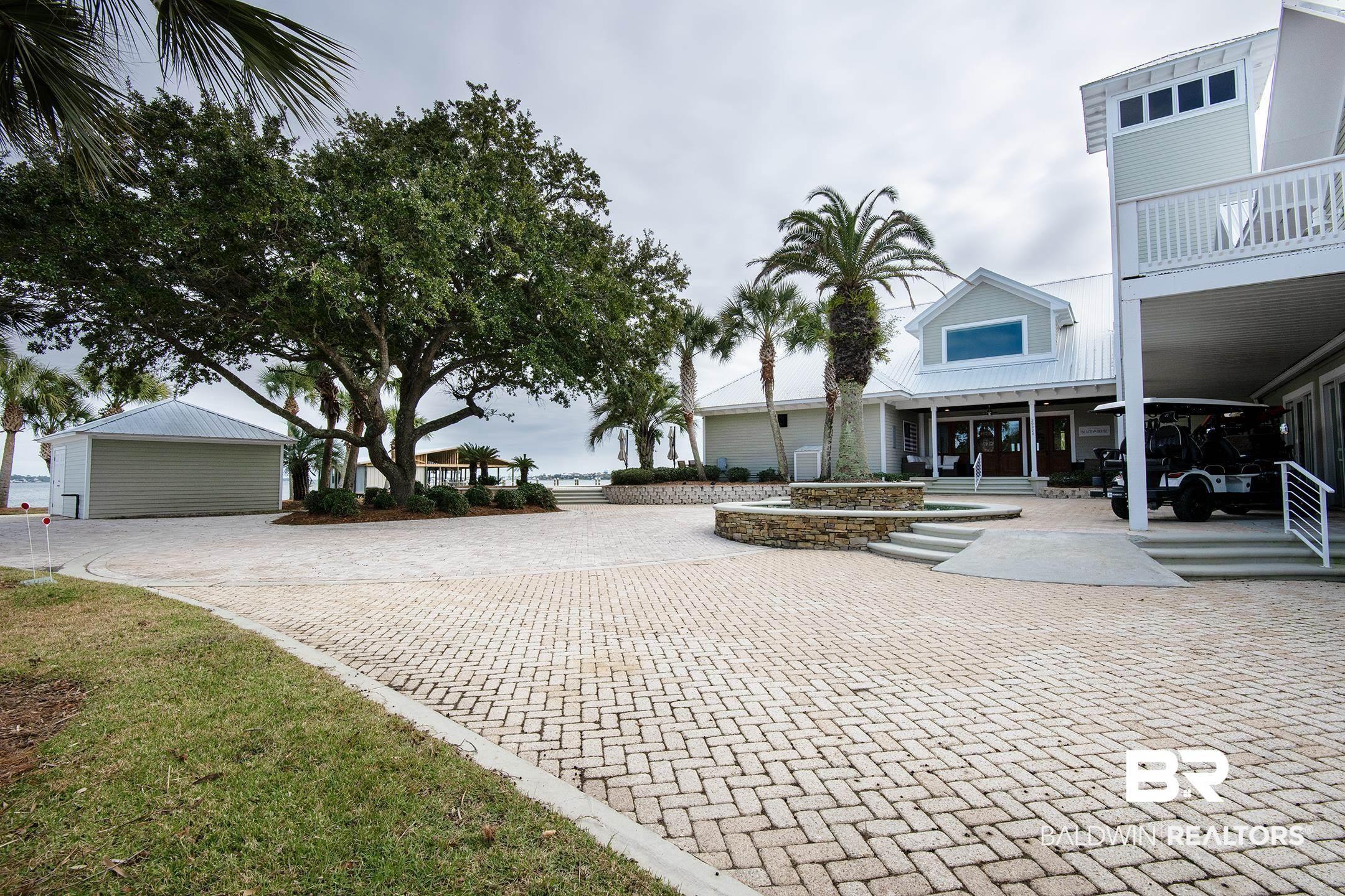 Image 4: Surrounding community with a patio area, decorative driveway, and a balcony