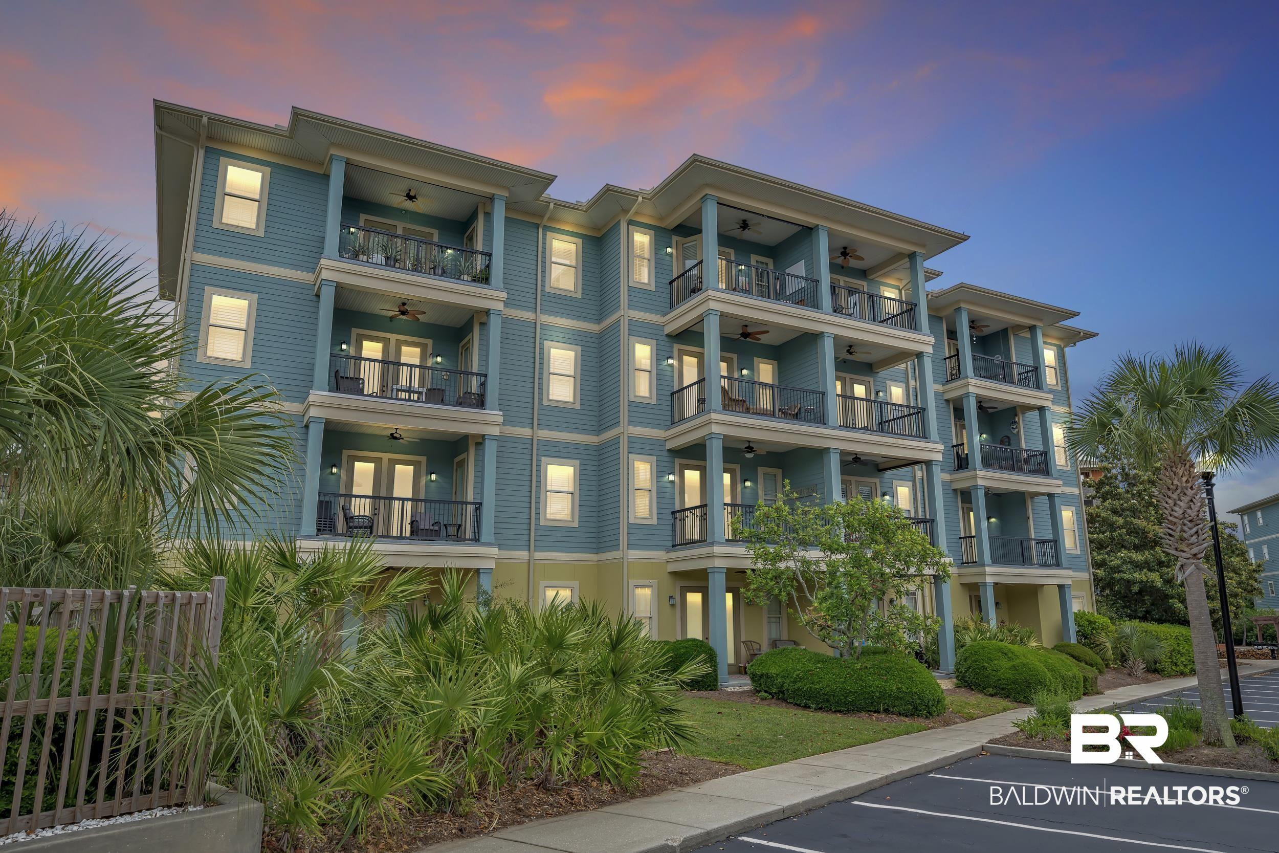 Image 3: Multi-story building featuring multiple private balconies, light blue siding, and white trim