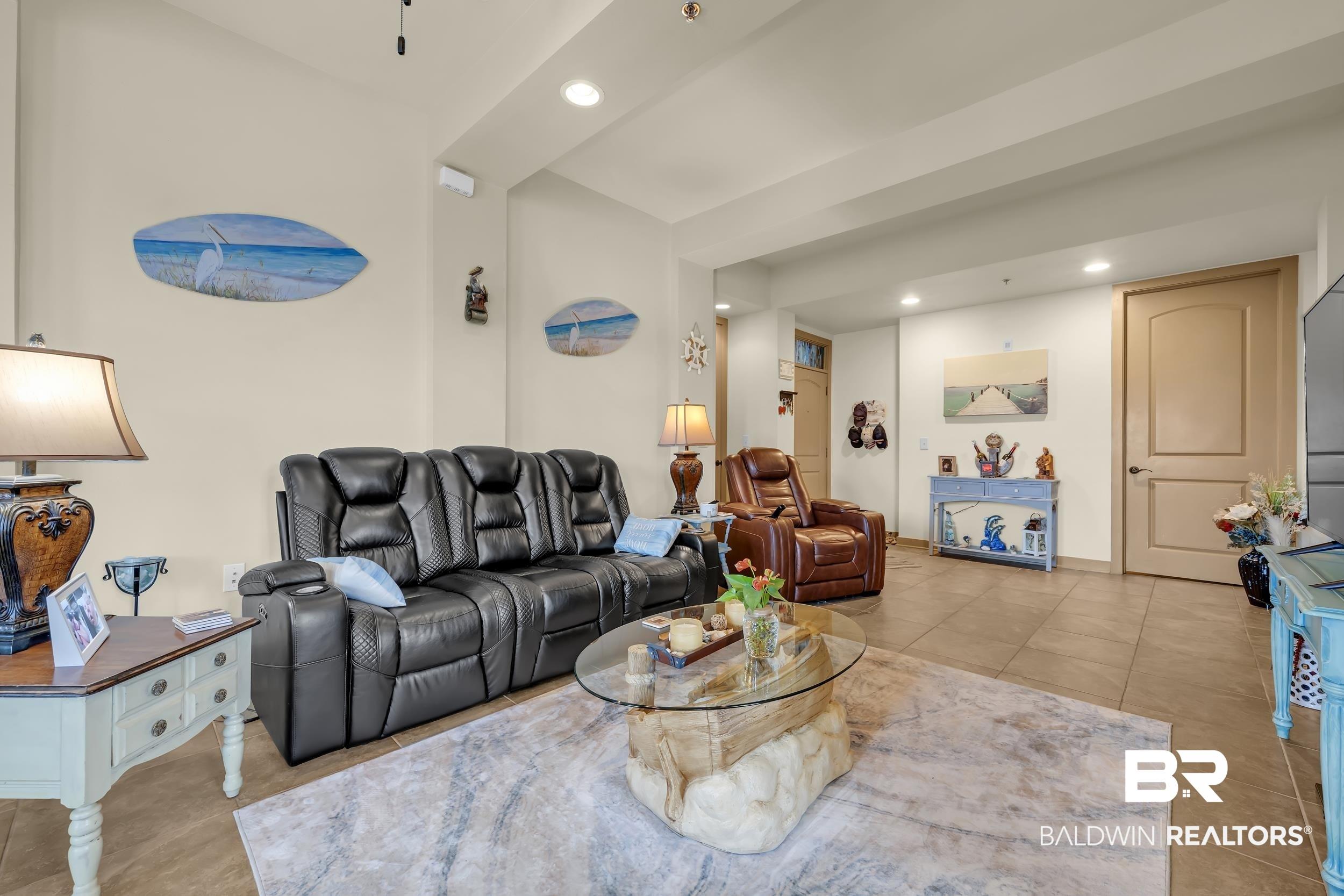 Image 4: Open-concept living area with light-toned walls and large format floor tiling