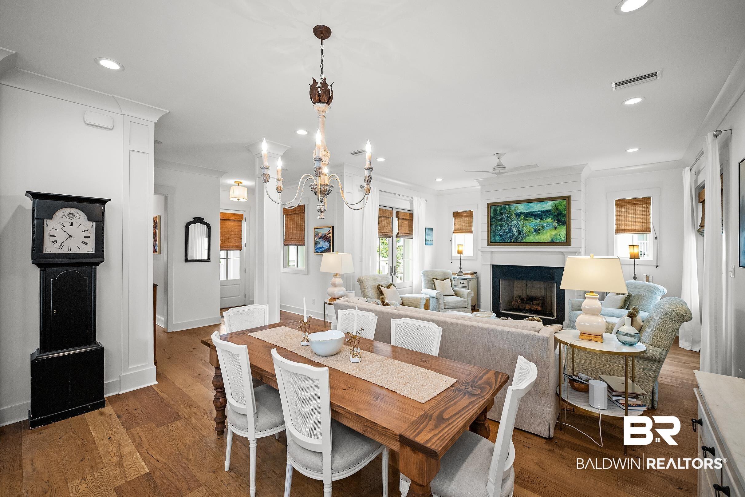 Image 3: Open-concept living space featuring wood-finish flooring throughout
