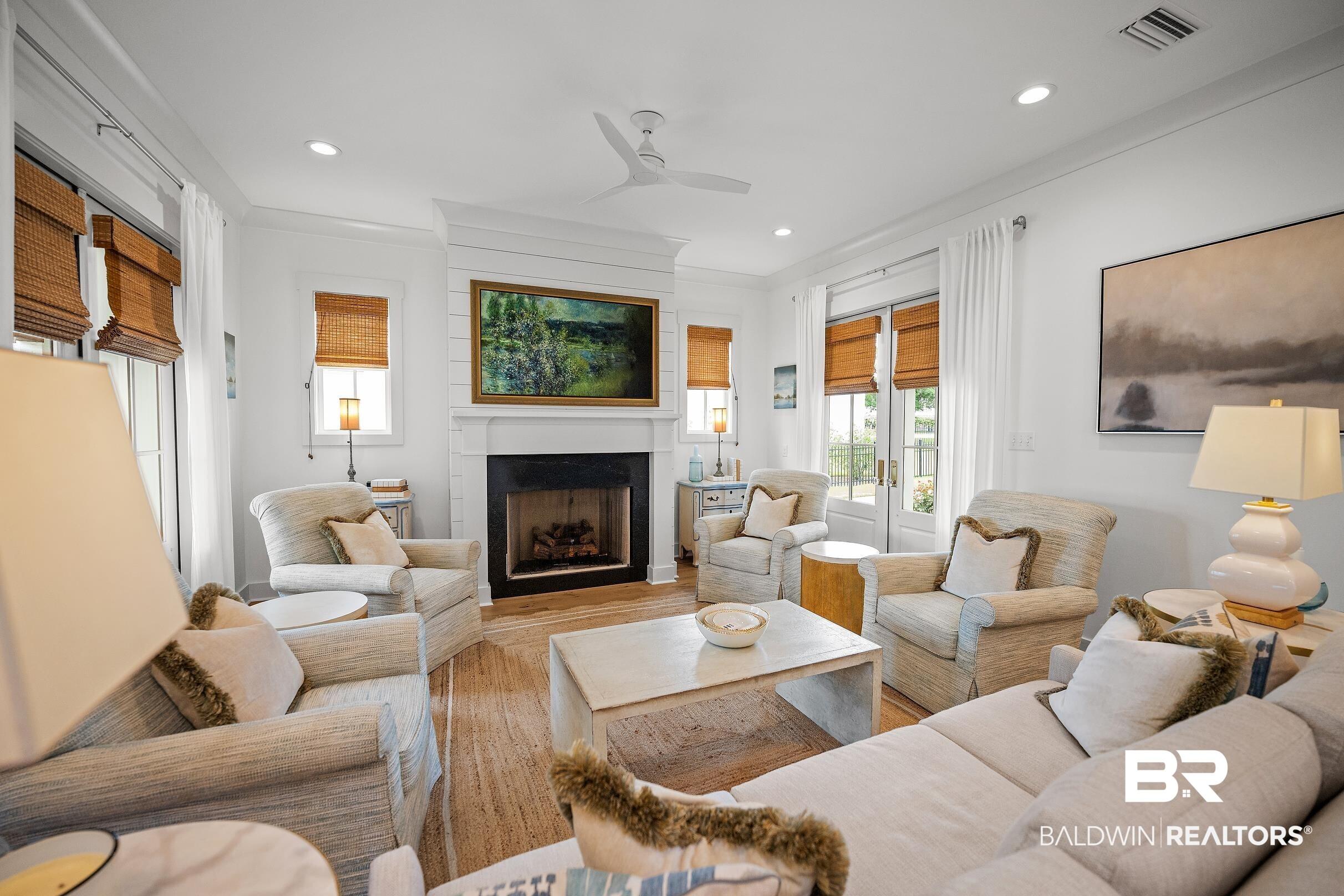 Image 4: Living area featuring wood-finish flooring and recessed lighting