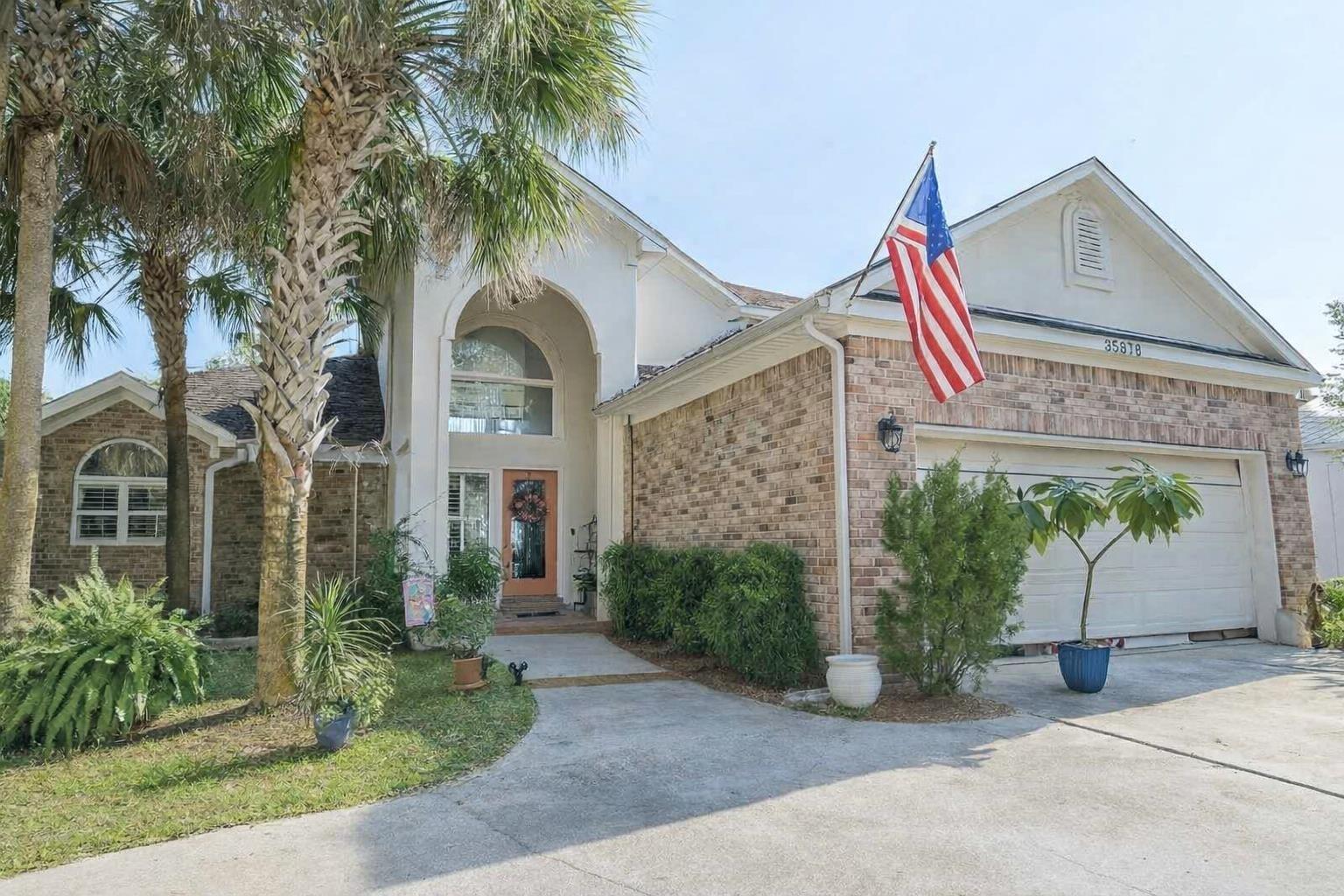 Image 2: Discover this beautifully maintained single-family home in the sought-after Lillian, Alabama area. Featuring a brick and stucco exterior, arched entryway, and two-car garage, this property offers timeless style and functionality.