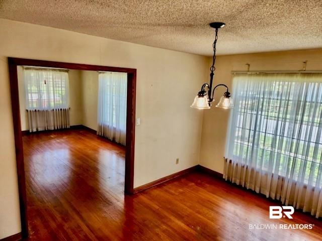 Image 4: Interconnected living spaces featuring polished wood-finish flooring throughout