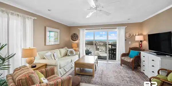 Image 3: Living area featuring crown molding, light tile patterned floors, a textured ceiling, and ceiling fan