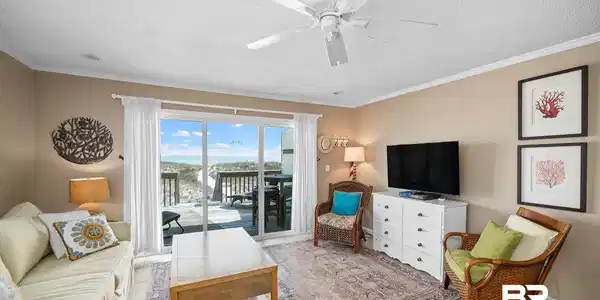 Image 4: Living area with a ceiling fan, ornamental molding, a textured ceiling, and light tile patterned floors