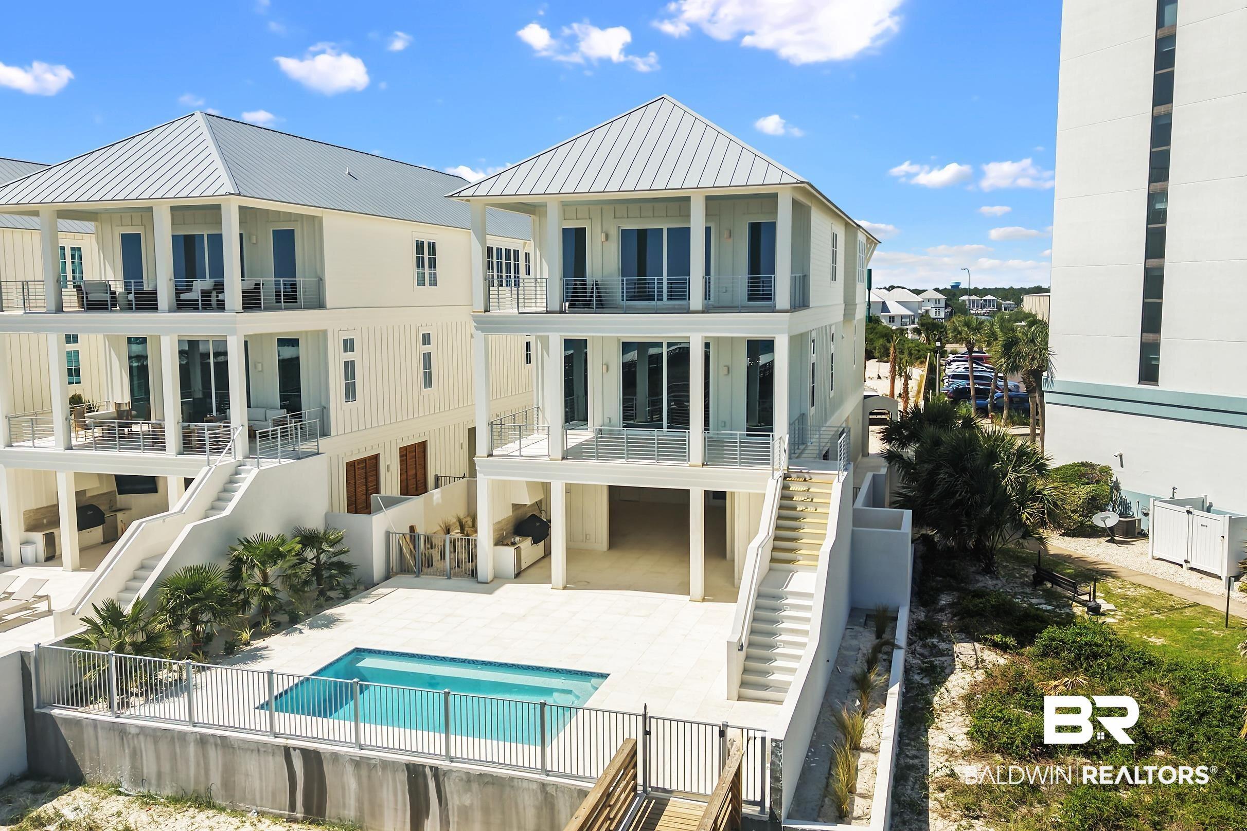Image 2: Coastal-inspired residence featuring a private pool with surrounding patio, multi-level balconies, and a metal roof