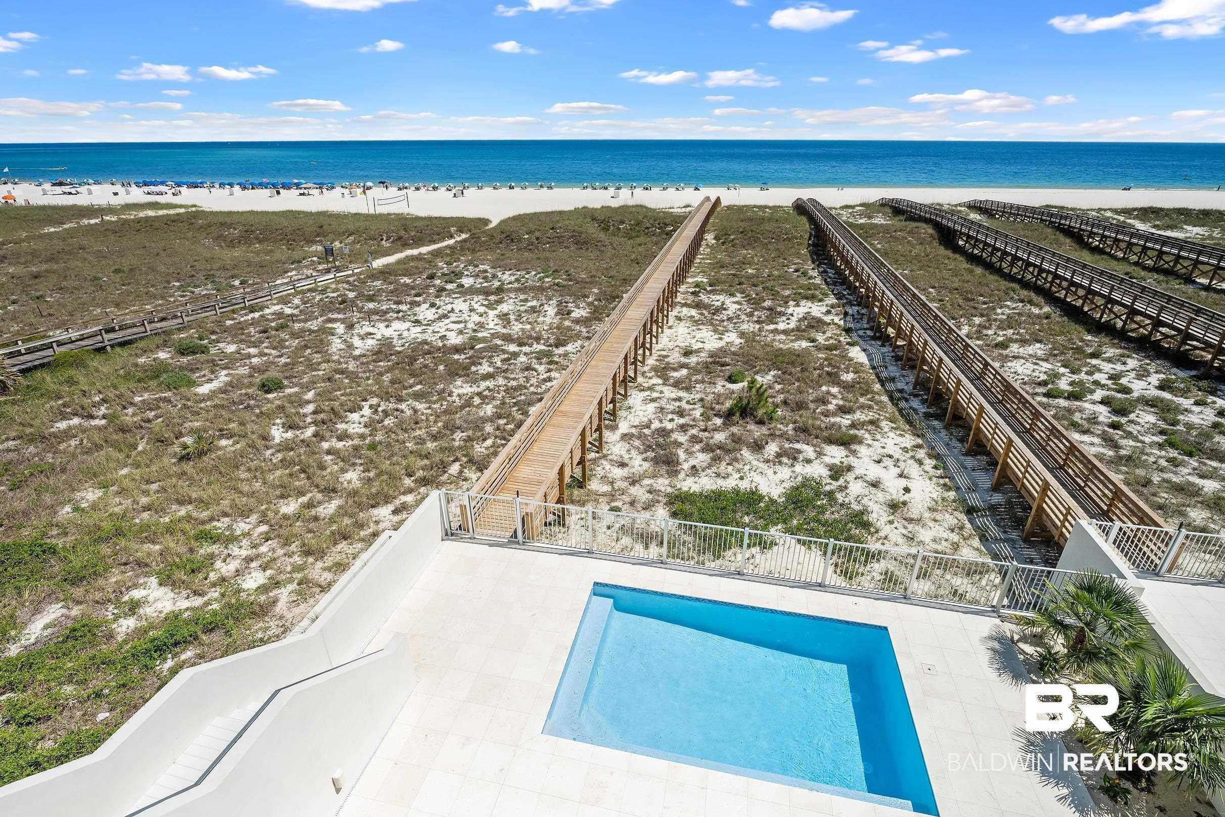 Image 4: Outdoor swimming pool with a white tile surround, bordered by a white metal fence