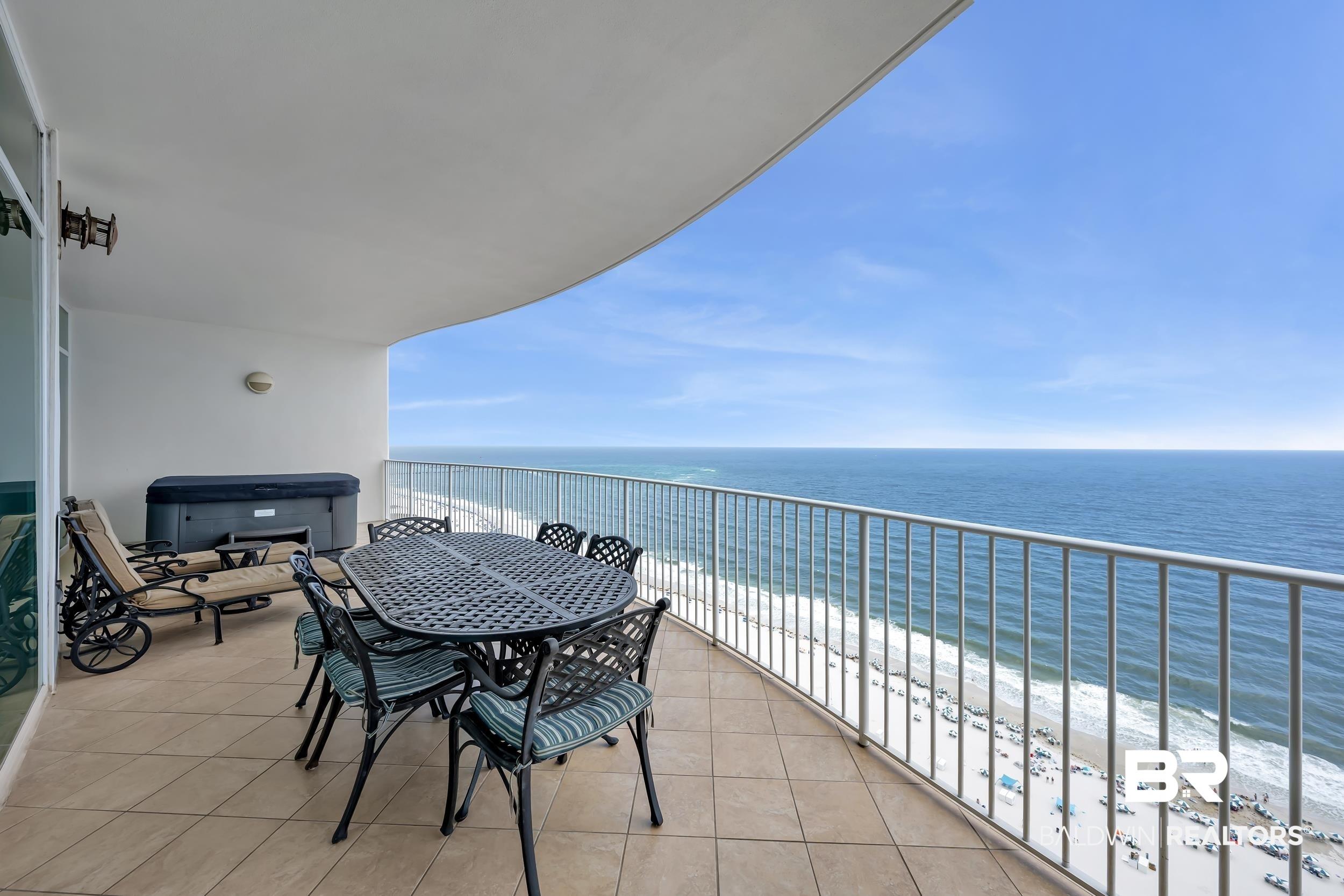 Image 2: Spacious outdoor balcony with tile flooring, featuring a metal railing system