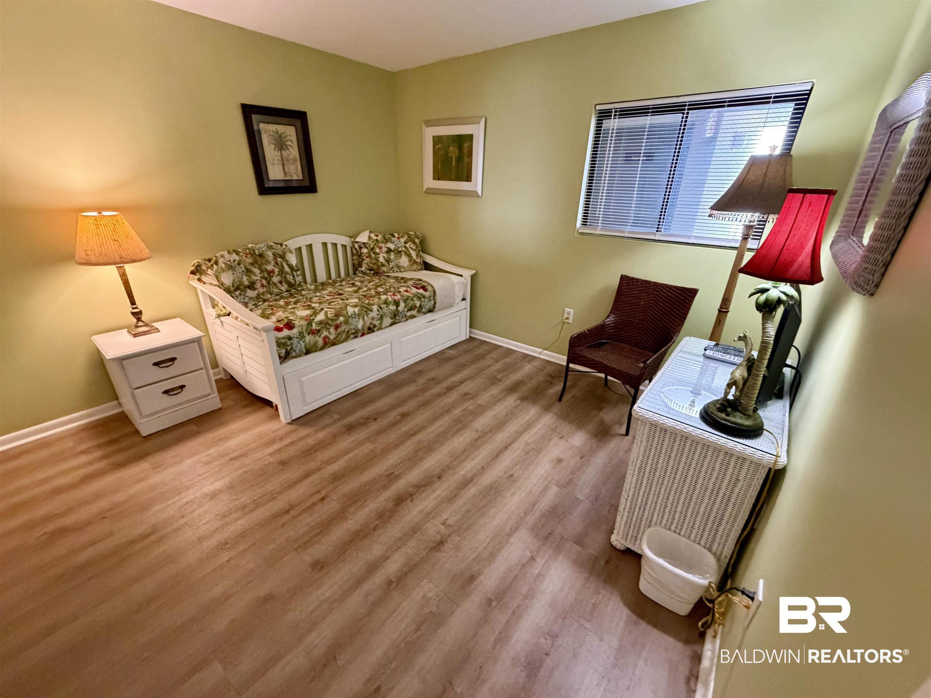 Image 4: Bedroom with baseboards and light wood-type flooring