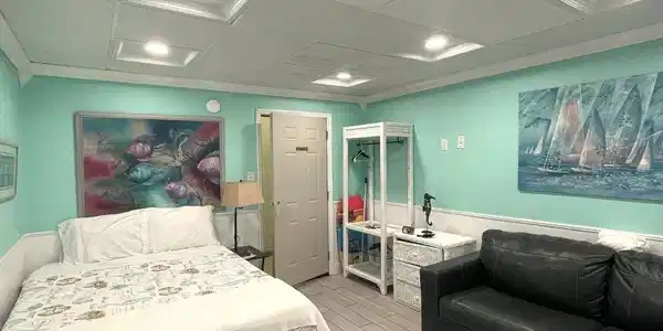Image 3: Bedroom with a drop ceiling, wood tiled floors, wainscoting, and recessed lighting