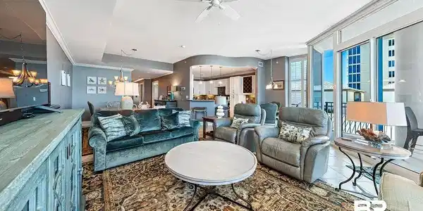 Image 3: Living room featuring ceiling fan, a chandelier, a textured ceiling, and expansive windows
