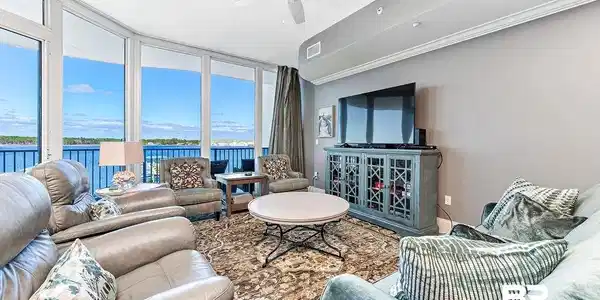 Image 4: Living area featuring a ceiling fan and floor to ceiling windows