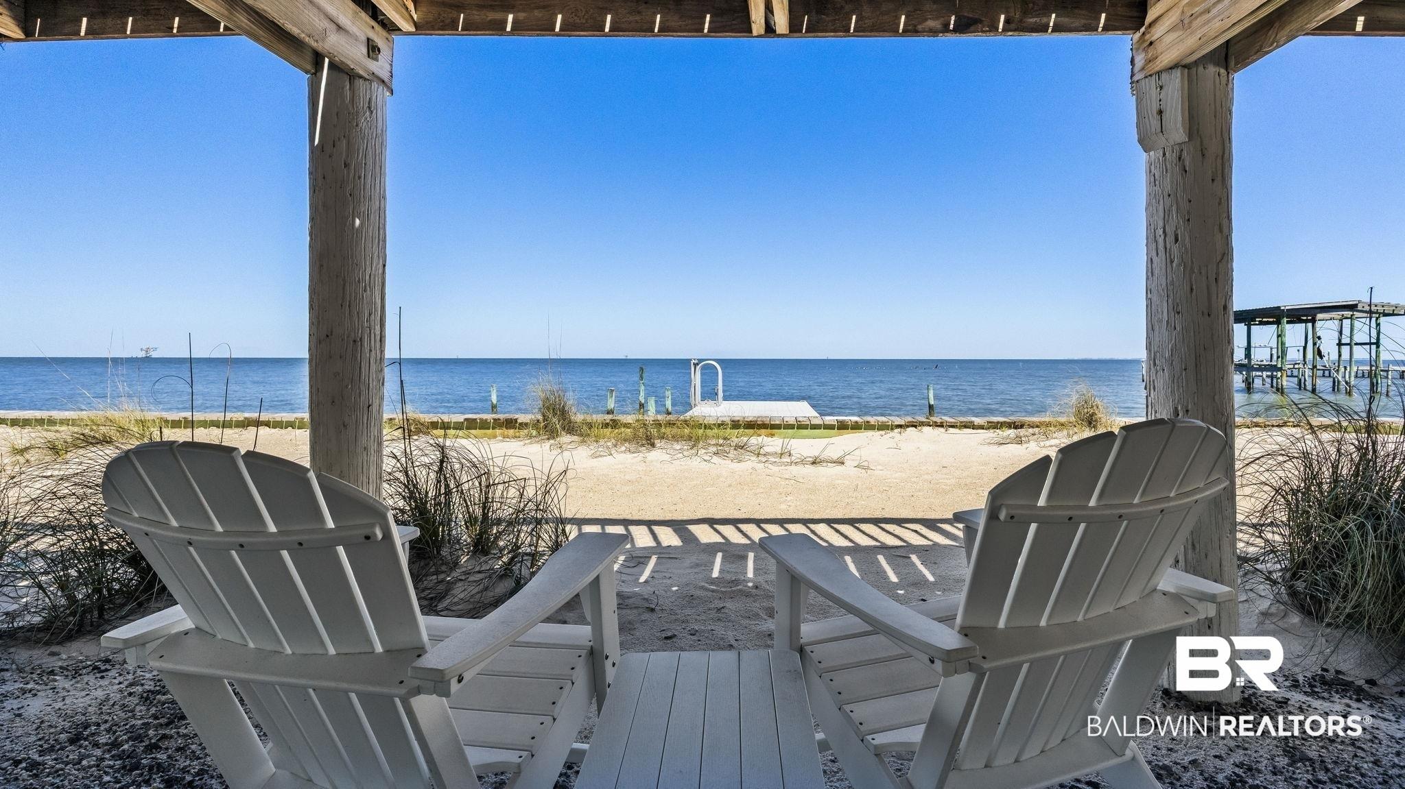 Image 2: View of patio featuring view of water and beach