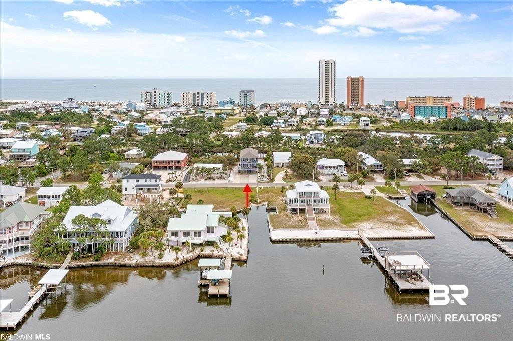 Image 3: Waterfront lot featuring a private boat dock, open water access, and a sandy shore