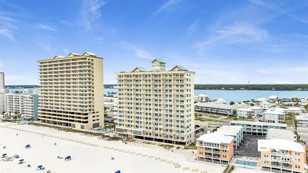 Image 1: Beachfront high-rise building featuring multiple balconies