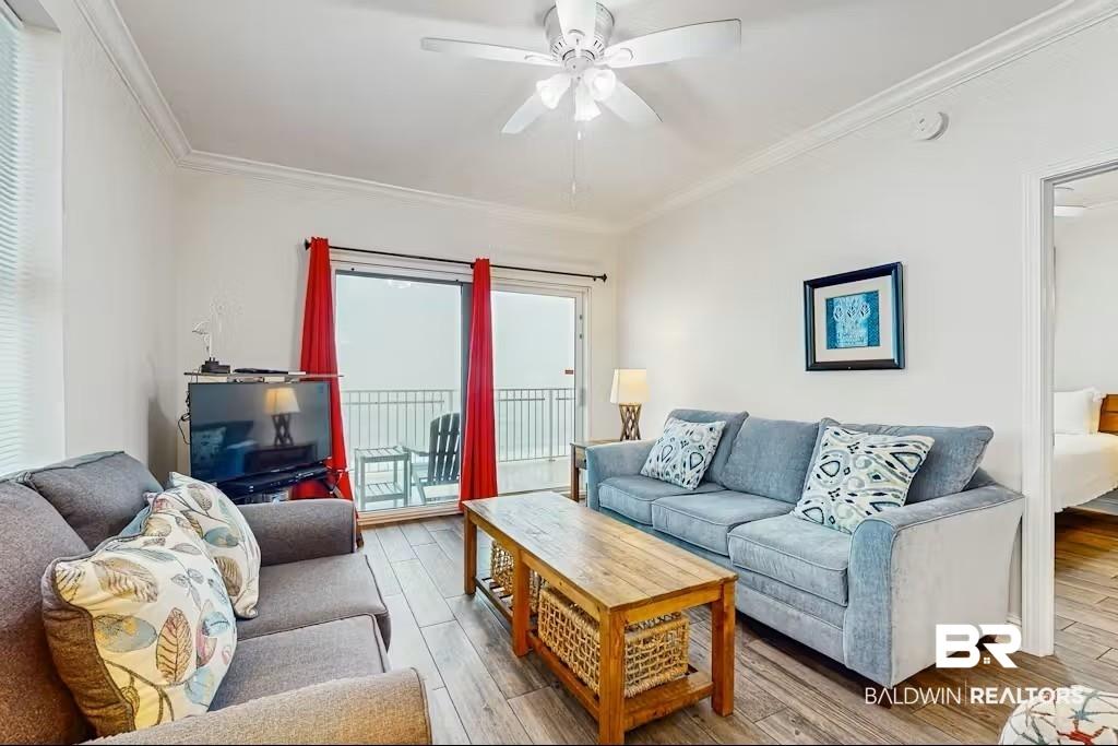 Image 2: Living area featuring wood-finish flooring, a ceiling fan, and crown molding