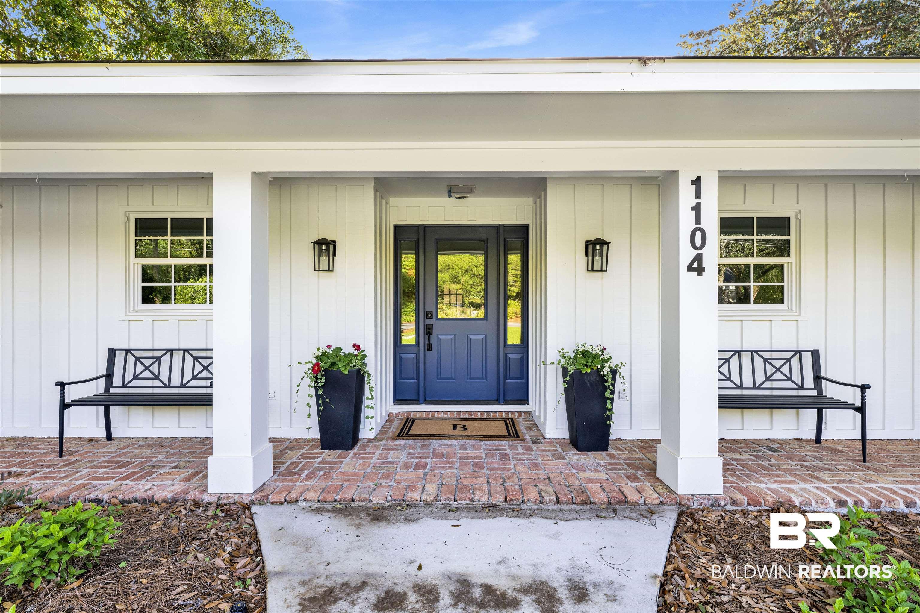 Image 2: View of exterior entry featuring a porch and board and batten siding