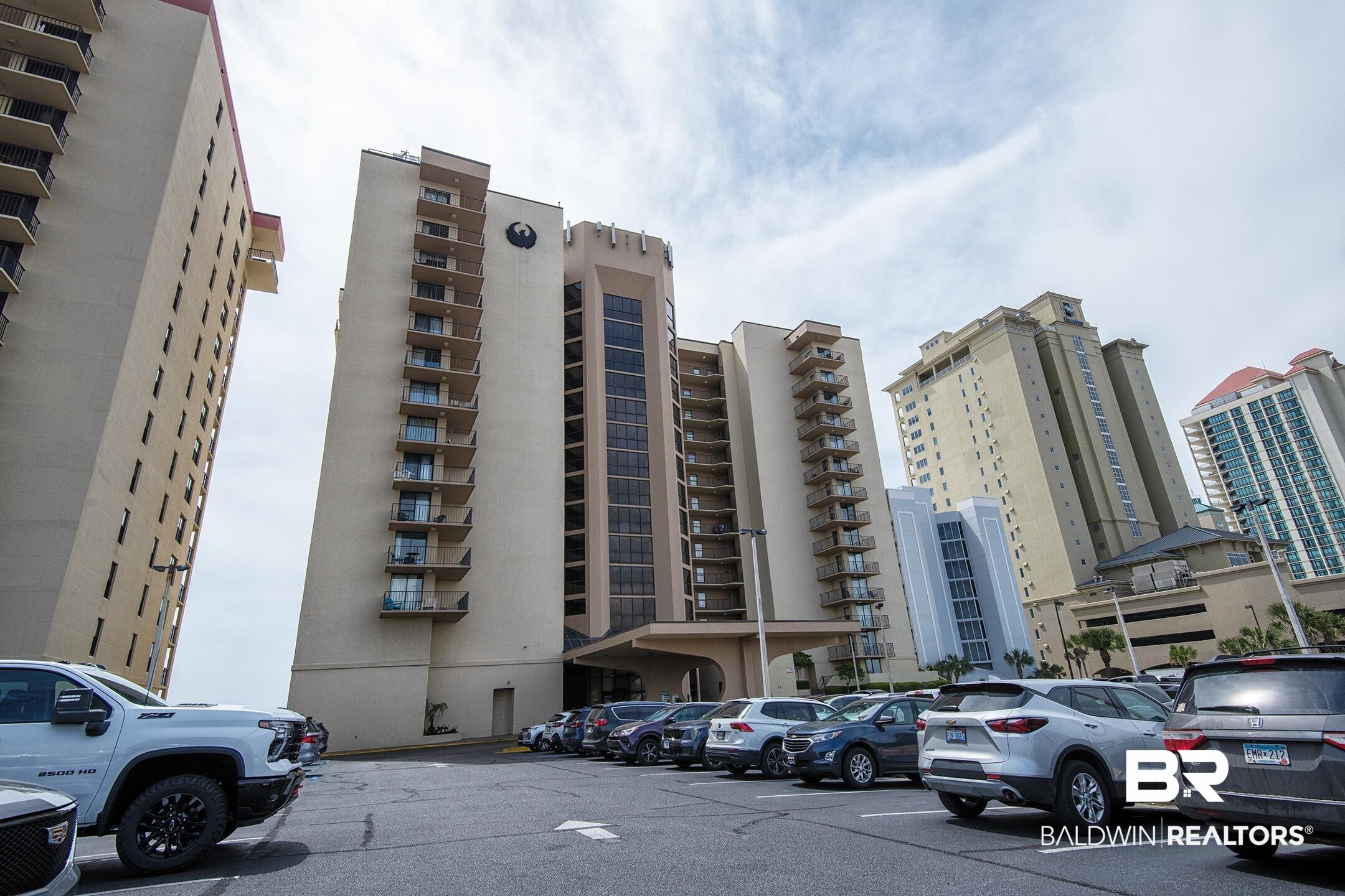 Image 1: View of apartment building / complex with uncovered parking
