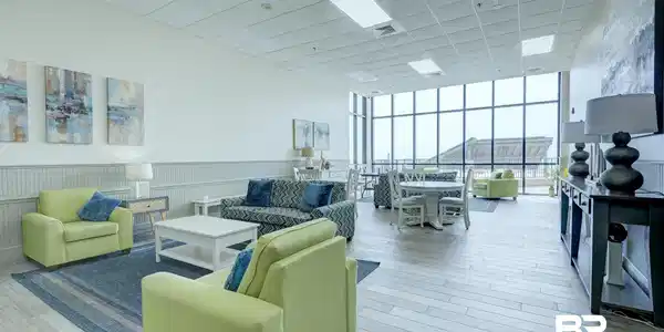 Image 3: Community lobby featuring floor to ceiling windows, a drop ceiling, and wainscoting