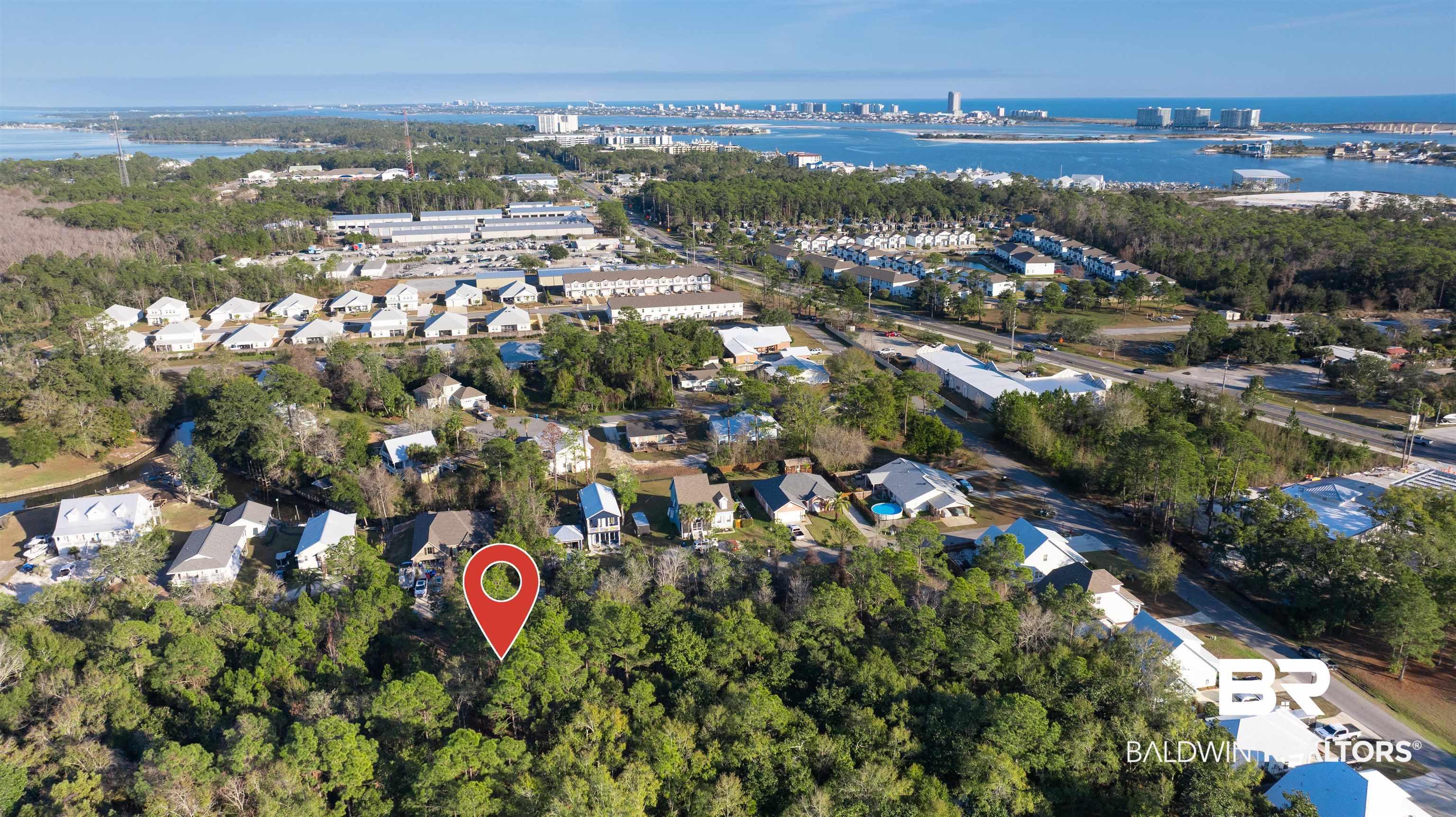 Image 3: Aerial overview of property's location with a large body of water and nearby suburban area
