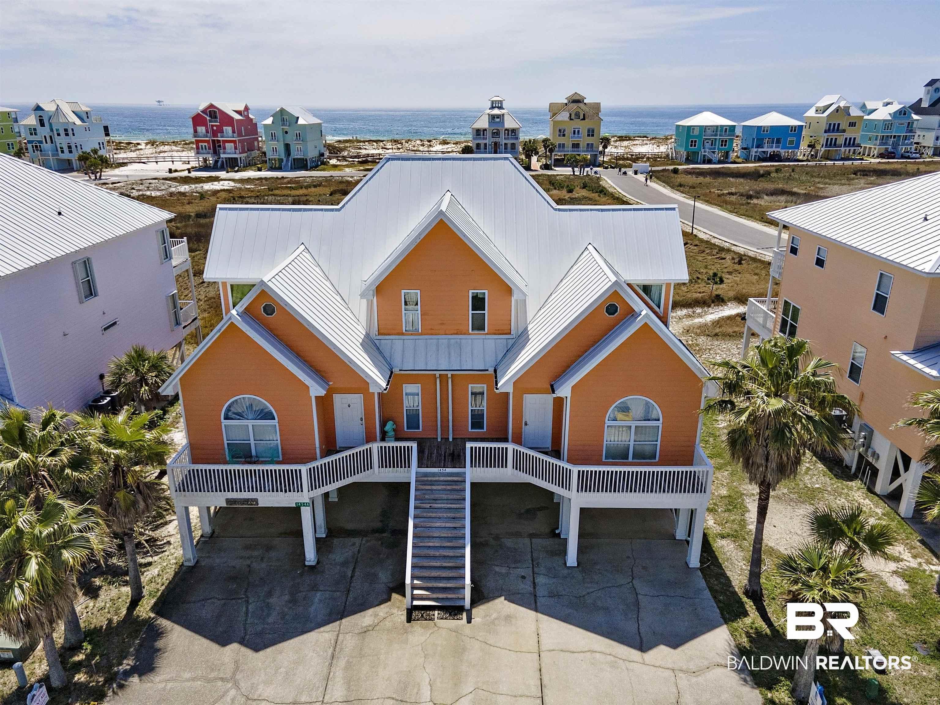Image 2: Coastal inspired home featuring a metal roof, a carport, and a residential view