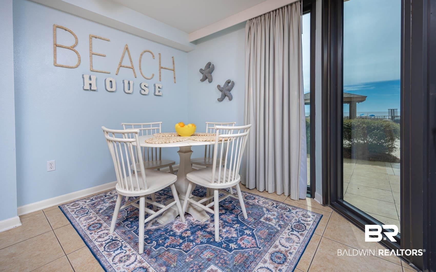 Image 3: Dining area featuring tile flooring, light blue walls, and a large sliding glass door with a patio beyond
