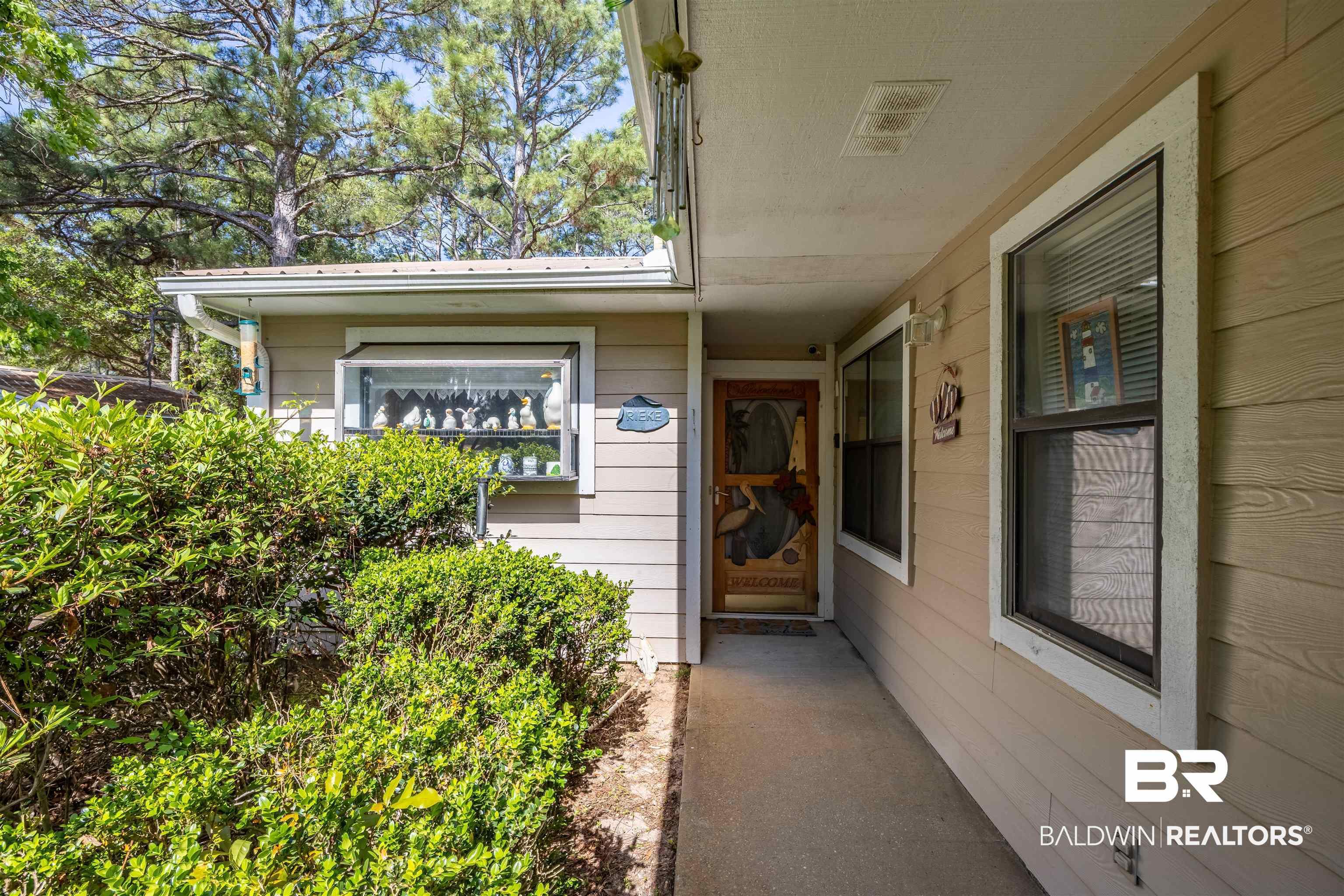 Image 4: Property entrance featuring a metal roof