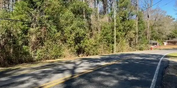 Image 3: View of road with a wooded view