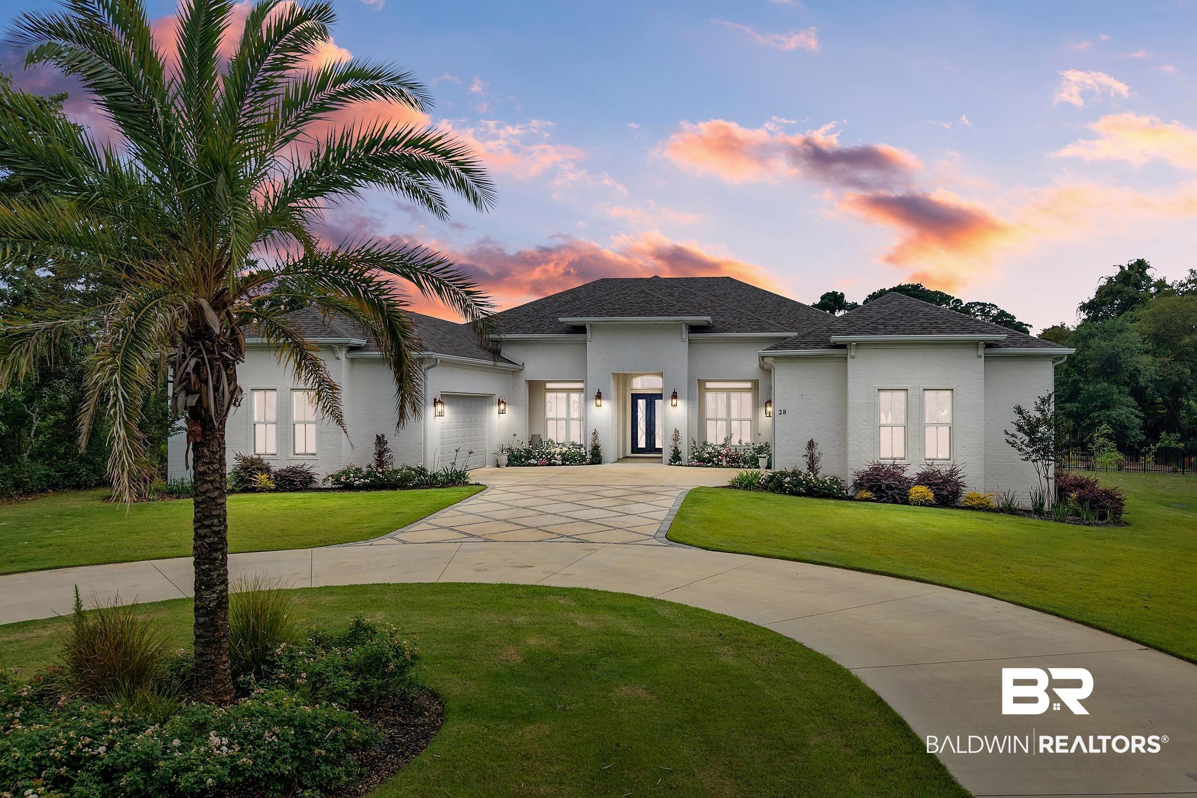 Image 1: Contemporary residence featuring a white brick exterior and a dark asphalt shingle roof