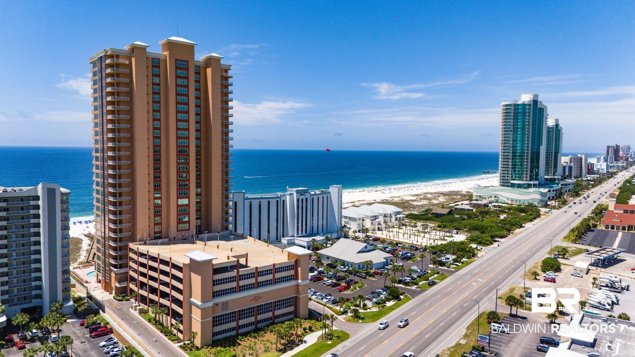 Image 4: Multi-story building featuring numerous balconies and an attached parking structure