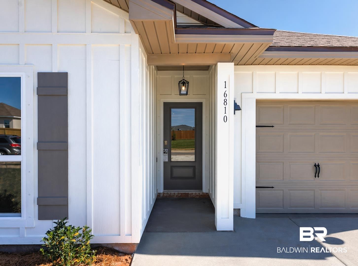 Image 4: Contemporary exterior featuring white board and batten siding