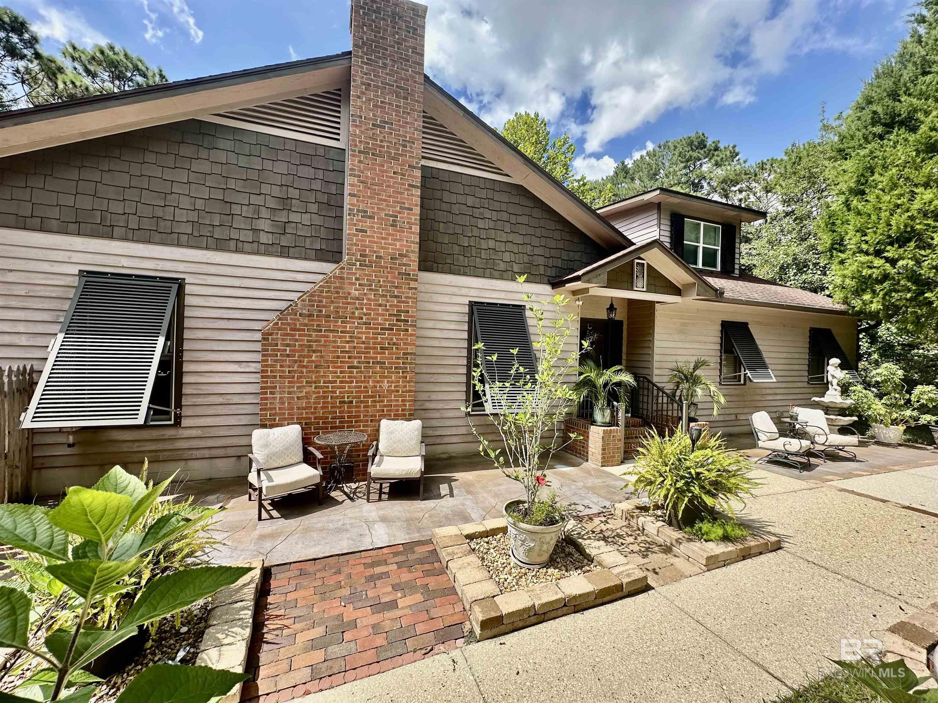 Image 2: Front of home with custom patios