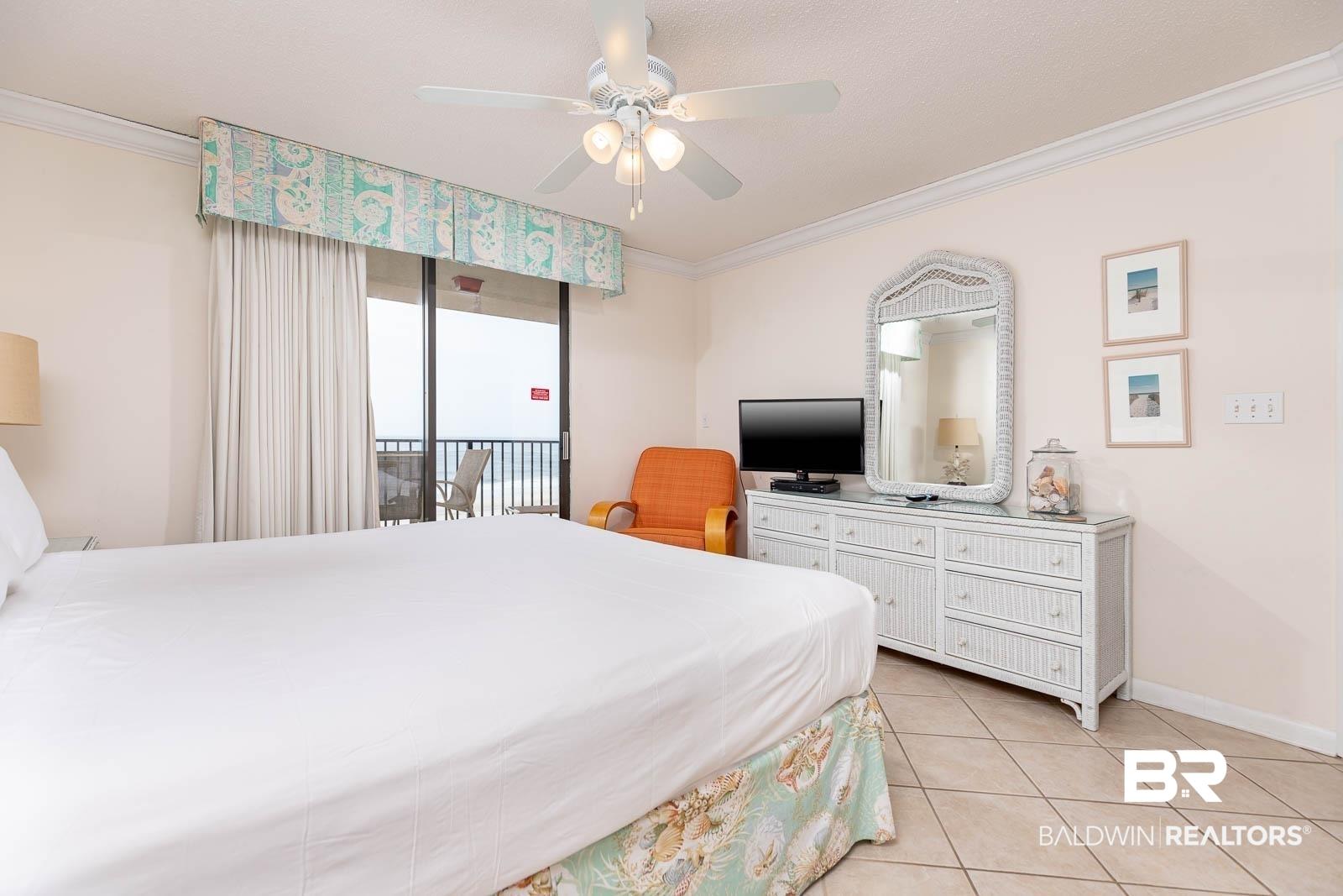 Image 3: Bedroom featuring ornamental molding, access to outside, a ceiling fan, and light tile patterned flooring