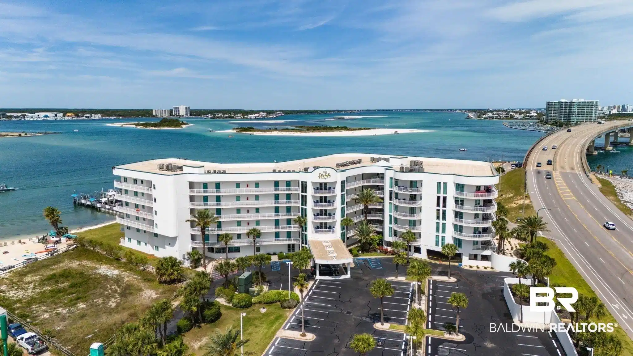 Image 1: Aerial view of a large body of water and apartment complex