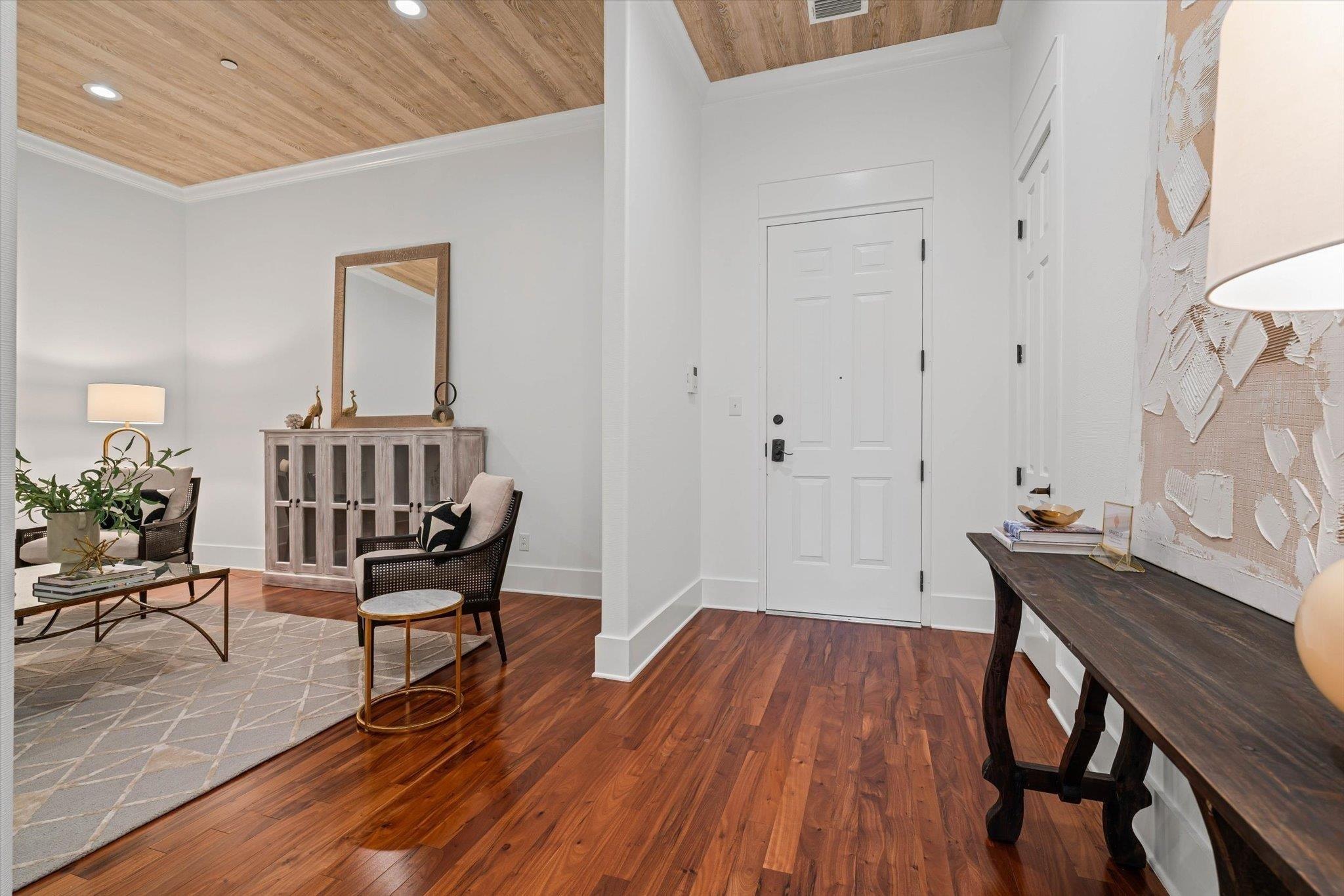 Image 3: Entryway featuring dark wood finished floors, wooden ceiling, ornamental molding, and recessed lighting