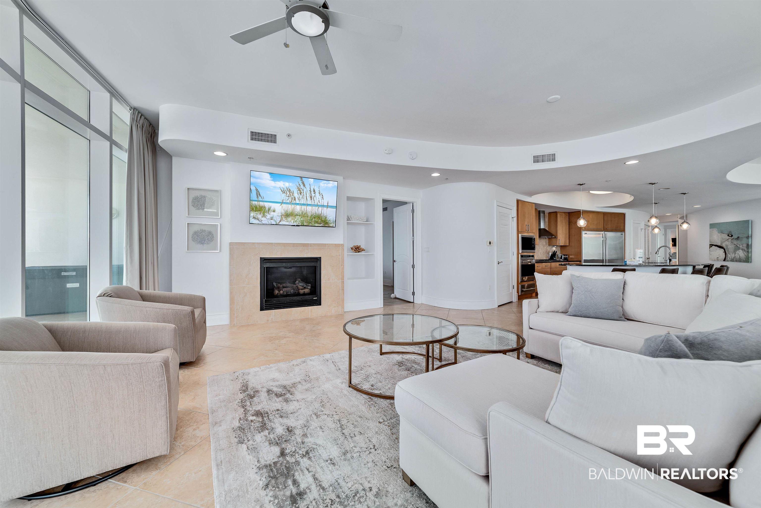 Image 3: Living area featuring visible vents, recessed lighting, a fireplace, and baseboards
