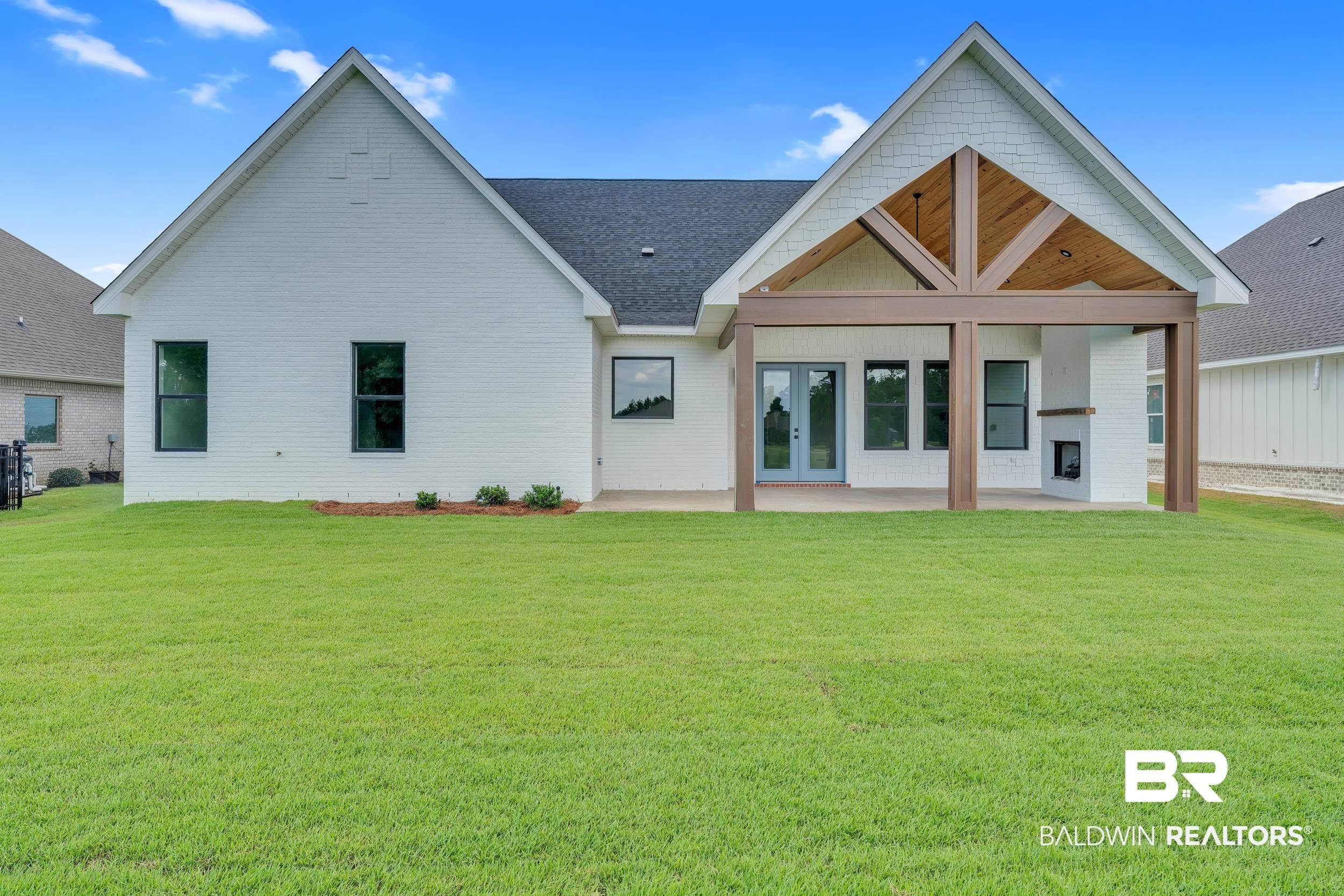 Image 3: Rear view of property with a patio area, a yard, and french doors