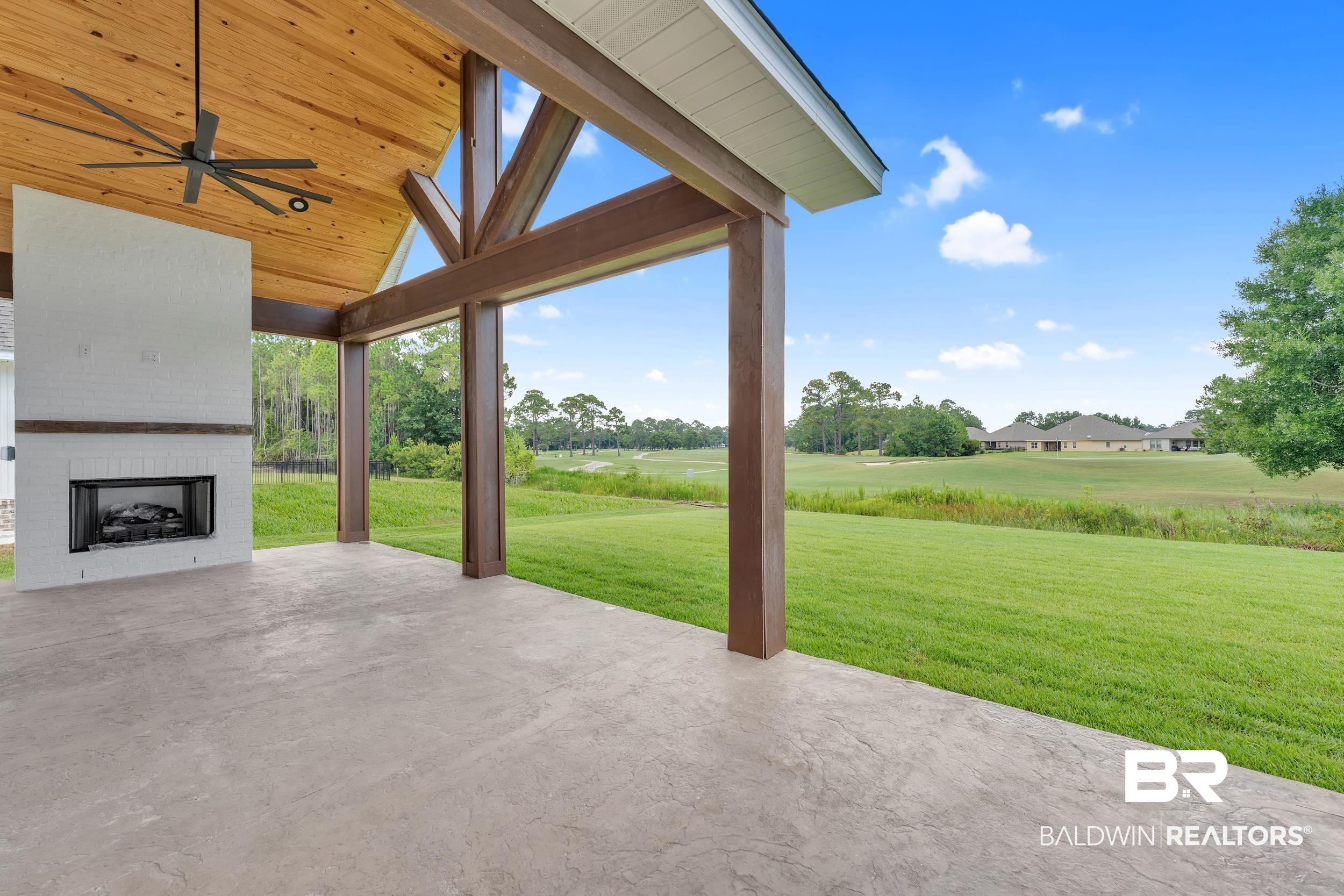 Image 4: View of patio / terrace with an outdoor brick fireplace and a ceiling fan