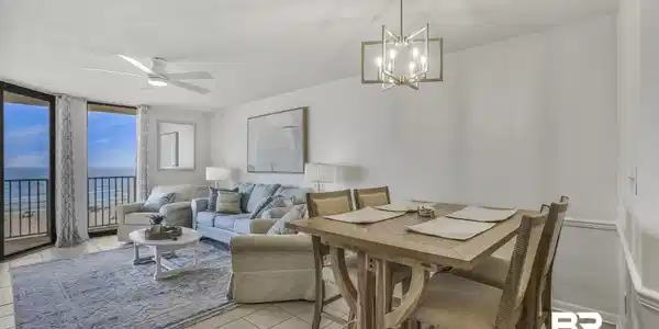 Image 2: Dining space featuring floor to ceiling windows, a ceiling fan, a textured ceiling, a water view, and light tile patterned floors