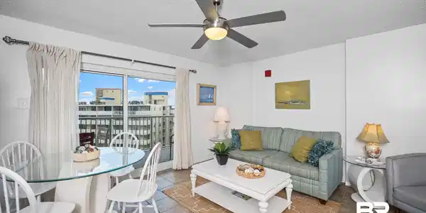 Image 4: Tiled living area featuring a textured ceiling and ceiling fan