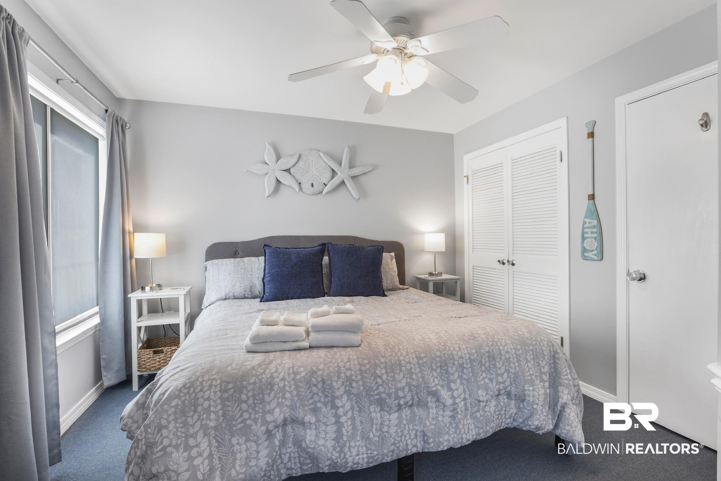 Image 4: Bedroom featuring a ceiling fan with integrated lighting, a window with roller shade, and light gray wall paint