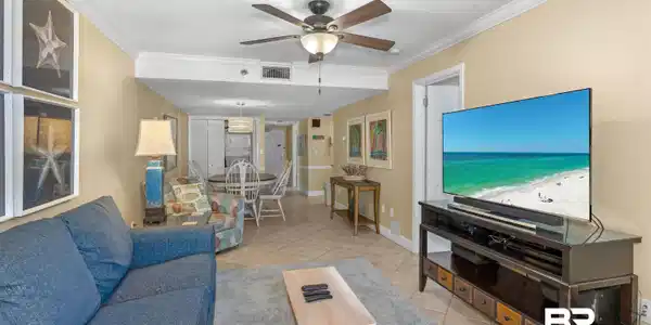 Image 4: Tiled living room featuring visible vents, ornamental molding, baseboards, and ceiling fan