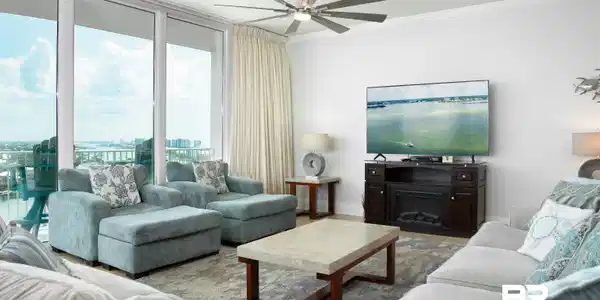 Image 3: Living area featuring floor-to-ceiling sliding glass doors, crown molding, and a multi-blade ceiling fan