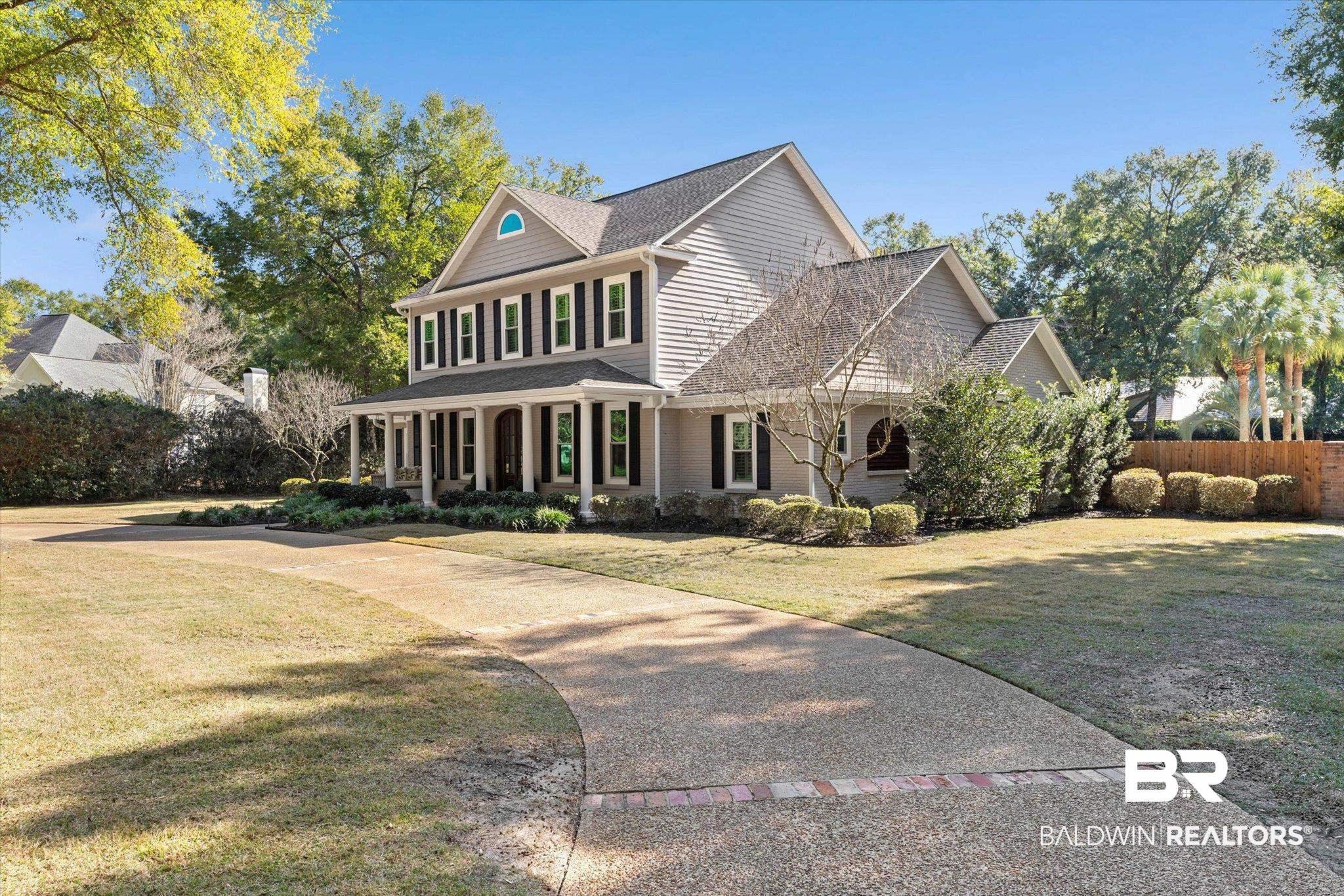 Image 4: Colonial house featuring a porch, a shingled roof, and concrete driveway